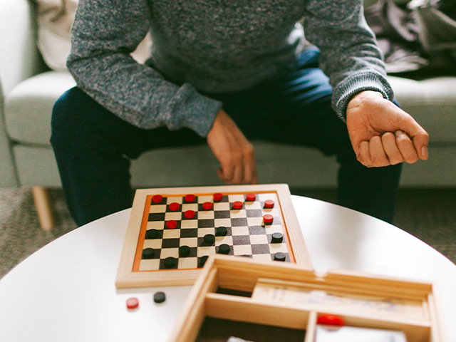 Man playing checkers.