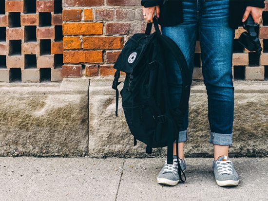 Woman Holding Backpack