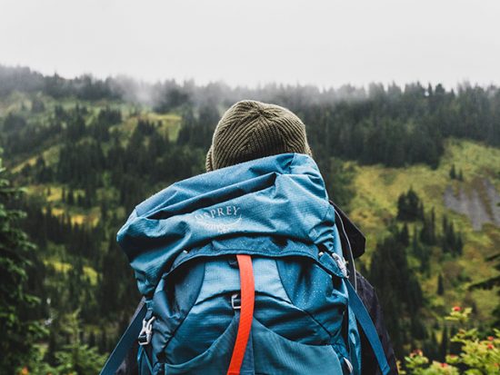 Backpacker navigating through mountain