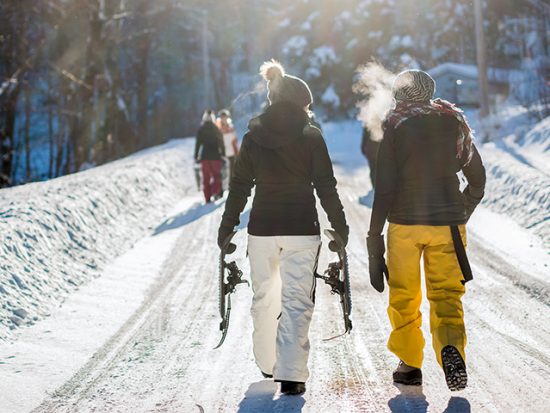 Two Women Walking in Snow