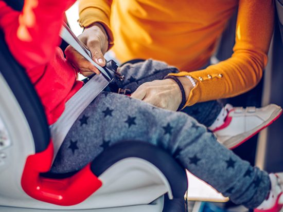 Traveling with a Car Seat, Mom Buckling in Child.jpg