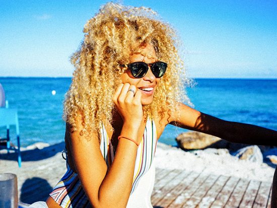 Woman sitting by the ocean in Punta Cana