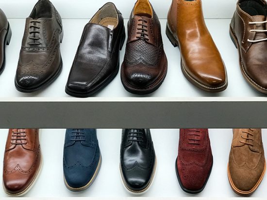 A row of men's shoes in a shoe store.
