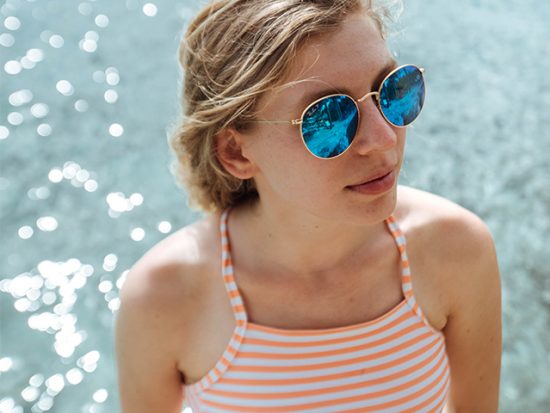 Girl Wearing Sunglasses at the Beach.