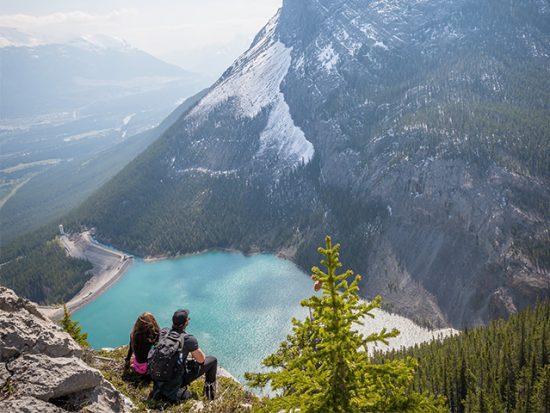 Man and Woman Overlooking Lake on Hike