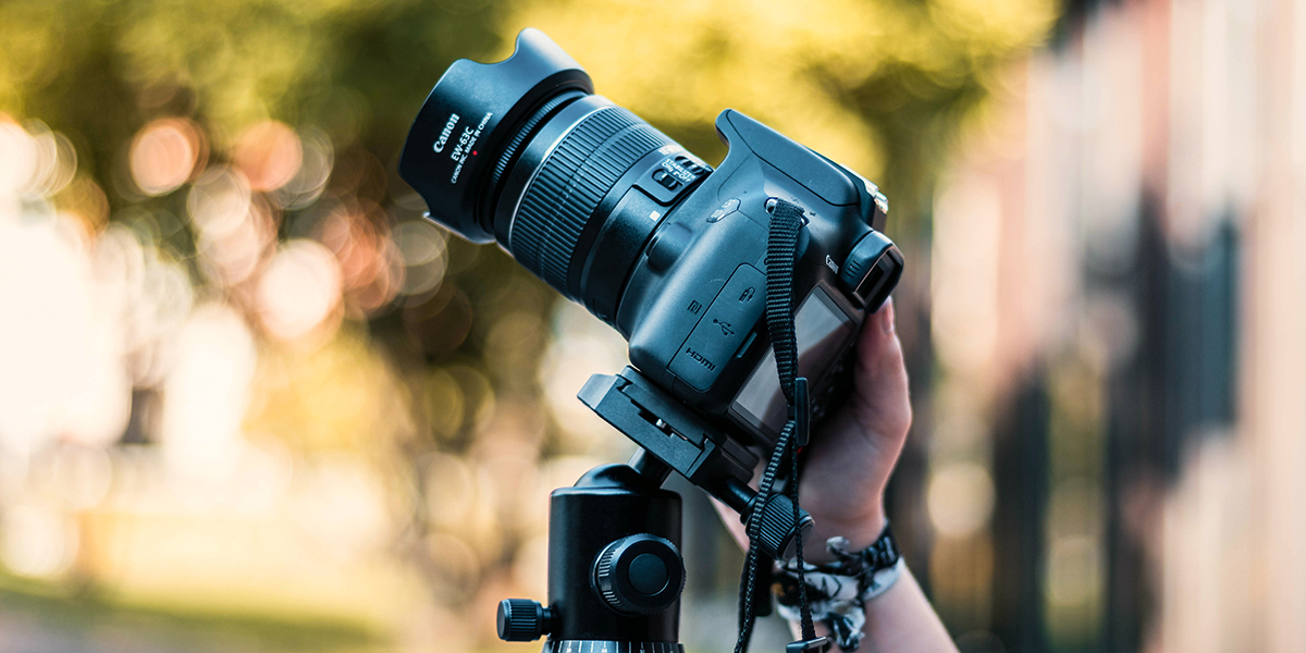 Close-up of camera on a tripod, tilted back.