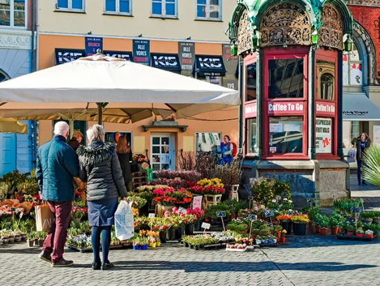 Couple outside of Public Market looking at flowers.