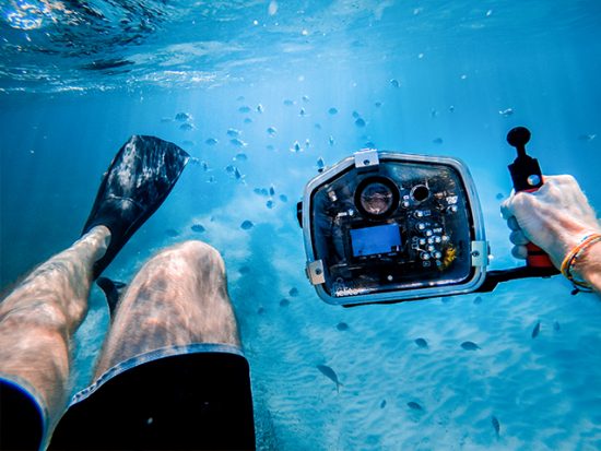Man Snorkeling with Camera in Underwater housing.