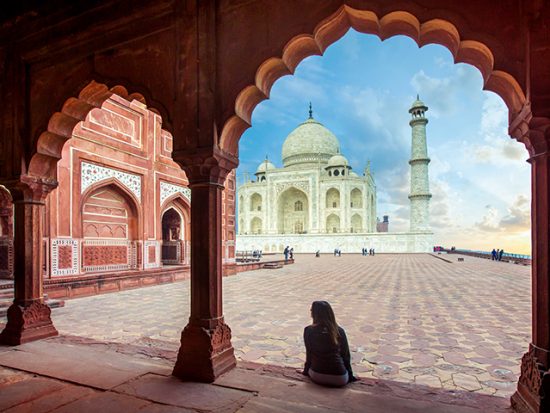 Woman Sitting and Looking at the Taj Mahal.