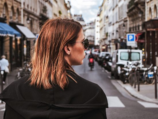 Woman standing on the street in paris.