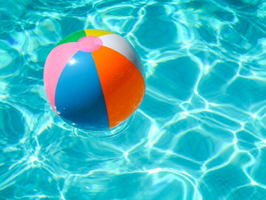 Beach ball floating in a pool.