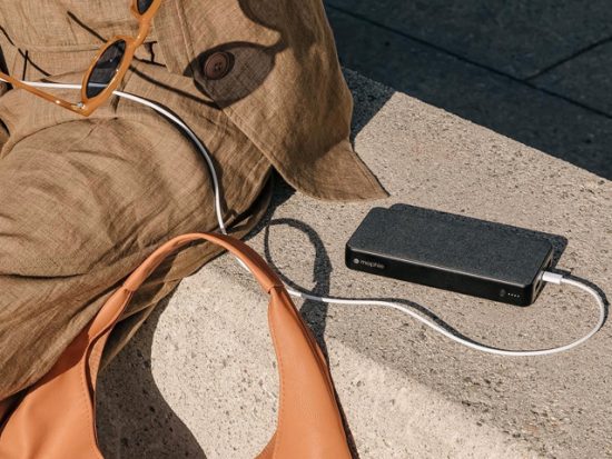 Woman sitting outside with a mophie charger.