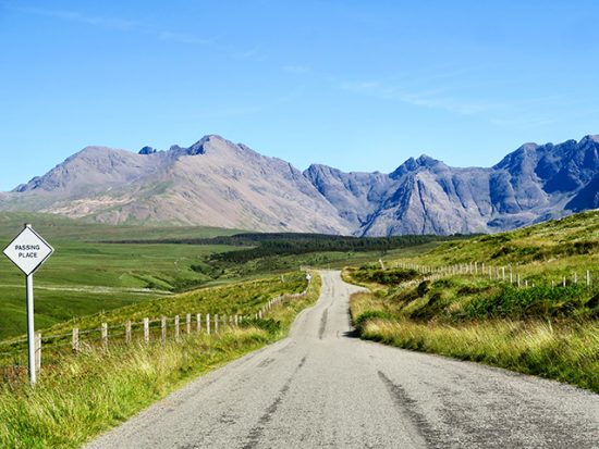 Empty road with mountains in the distance.