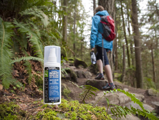 Man hiking with Sawyer Products SP543 Premium Insect Repellent.