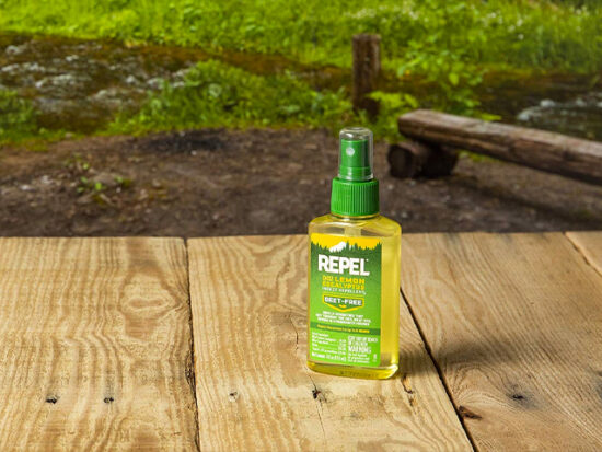 Outdoor shot of REPEL Plant-Based Lemon Eucalyptus Insect Repellent.