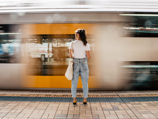 Woman standing on a platform waiting for the train.