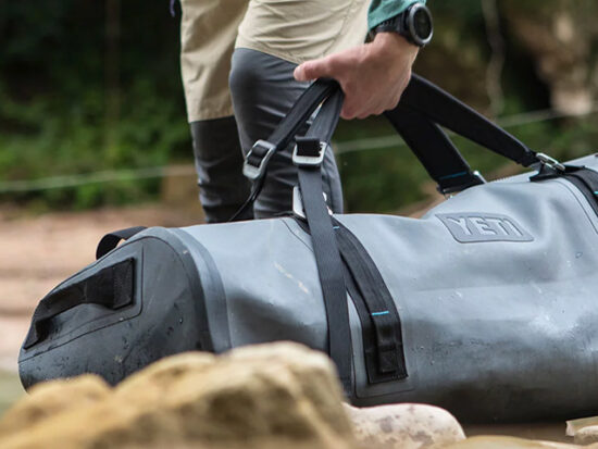 Yeti PANGA 100 Dry bag being carried by a man.