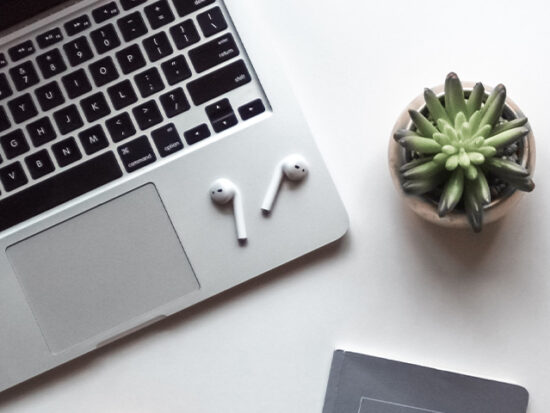 Airpods sitting on a macbook.