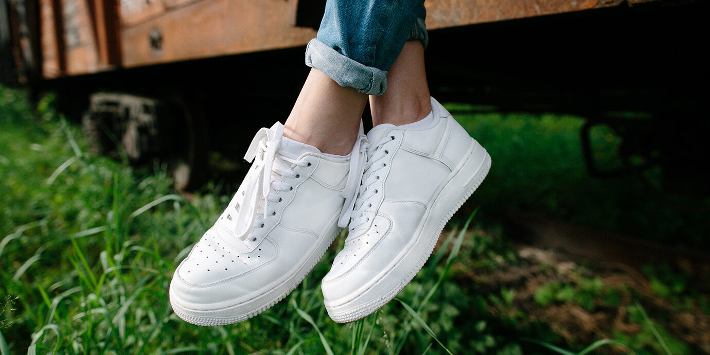 Close-up of woman's white sneakers.