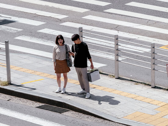  Couple in Seoul South Korea waiting to cross the street.