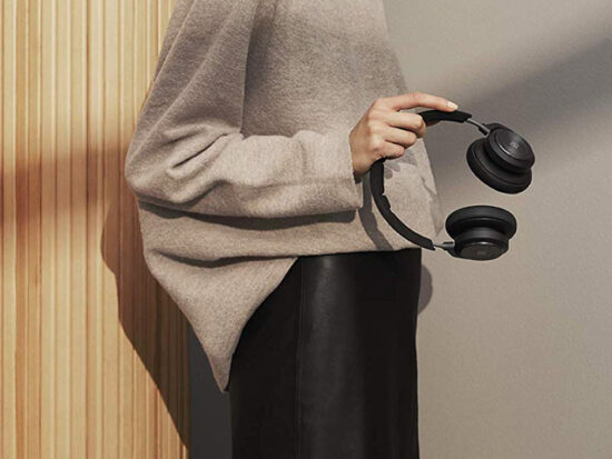 Woman Holding Bang & Olufsen Beoplay H9 3rd Gen Wireless Bluetooth Over-Ear Headphones.