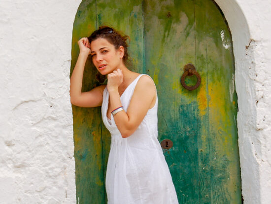 Woman standing in a doorway in Ibiza.